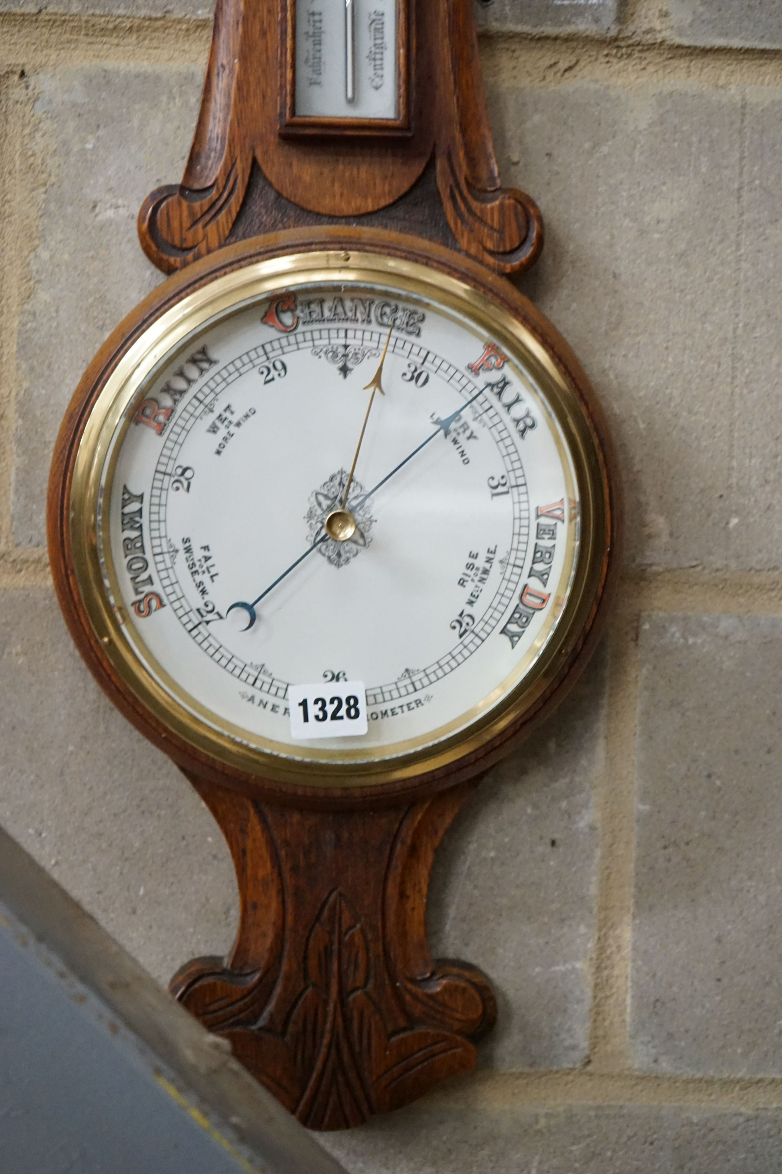 A late Victorian carved oak aneroid barometer and thermometer, height 84cm